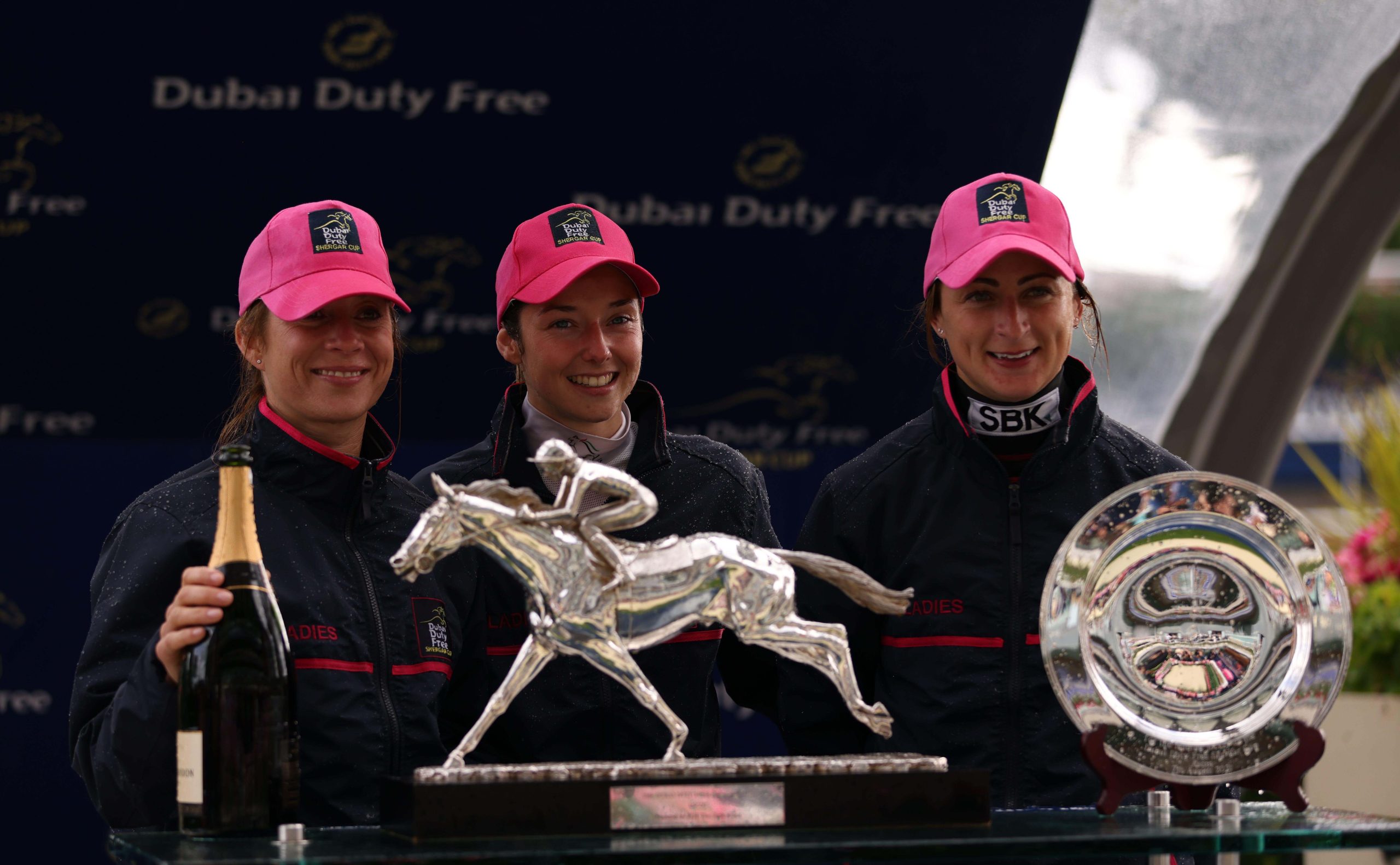 (left to right) Ladies team captain Hayley Turner, and jockeys Mickaelle Michel and Nicola Currie collecting the Dubai Duty Free Shergar Cup at Ascot Racecourse. Picture date: Saturday August 7, 2021. See PA story RACING Ascot. Photo credit should read: S