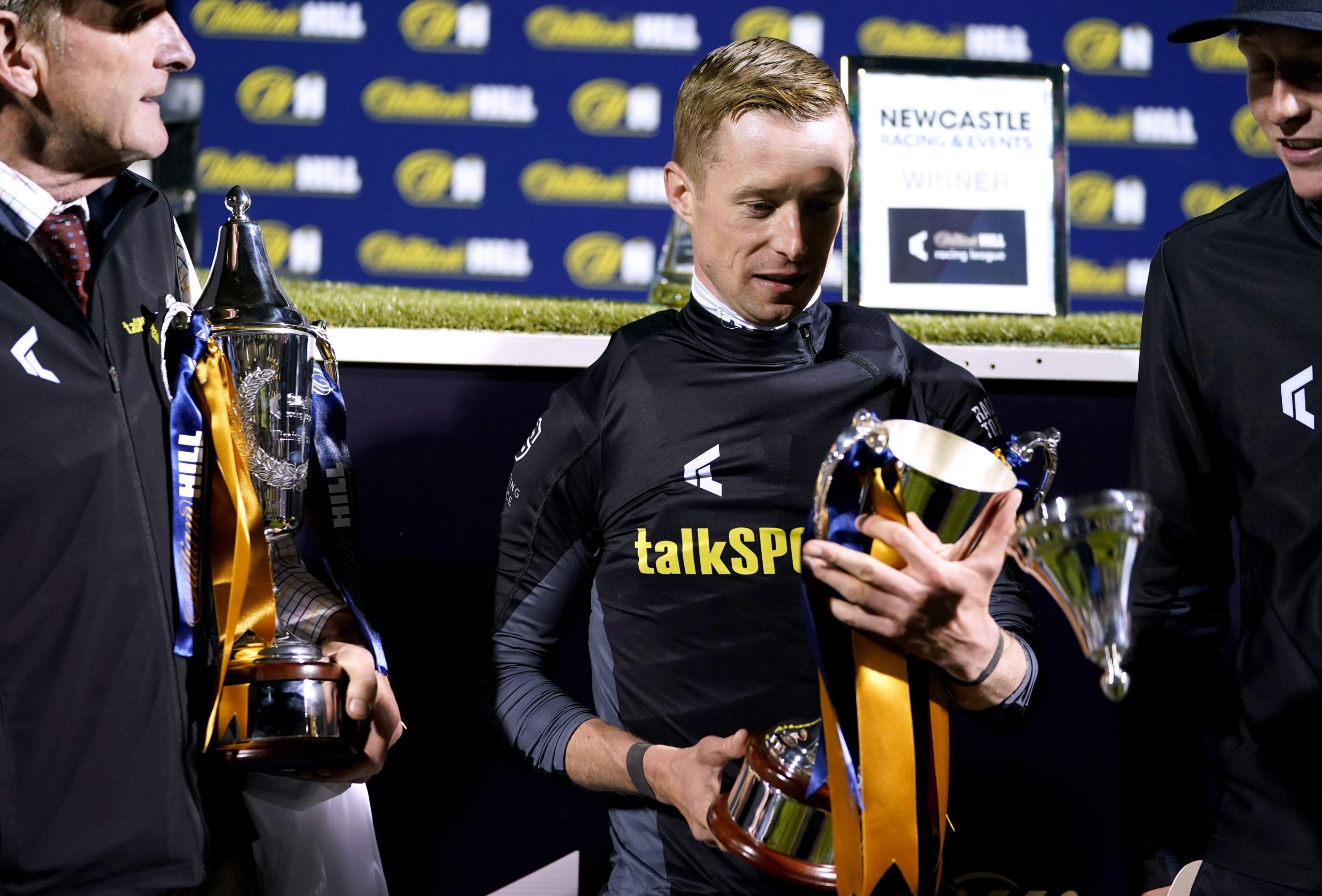 Jack Mitchell celebrates with his trophy after winning the leading jockey title during Race Day 6 of the William Hill Racing League at Newcastle Racecourse. Picture date: Thursday September 2, 2021.