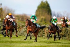 Any Second Now (white cap, right), chases home Minella Times in the 2021 Grand National.